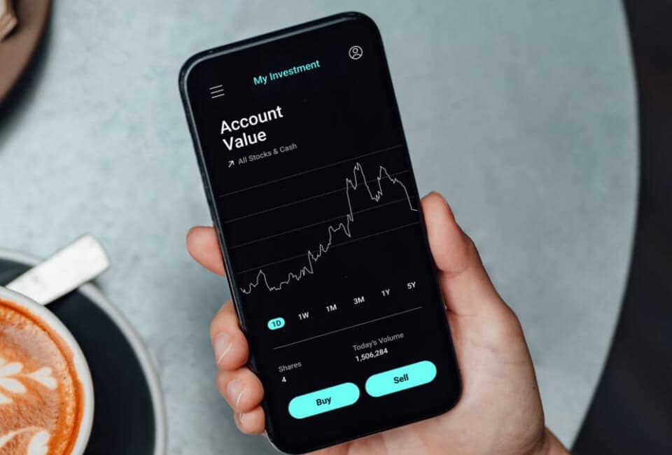 A person reviewing investment performance and stock market trends on a smartphone.